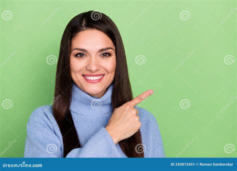 Photo Of Pretty Sweet Young Woman Wear Blue Sweater Smiling Pointing Finger Empty Space Isolated