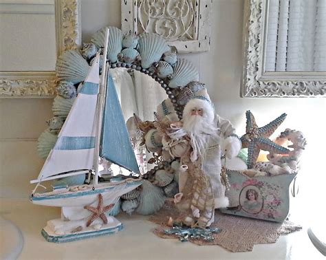 A Santa Clause Figurine Sitting On Top Of A Table Next To A Sailboat