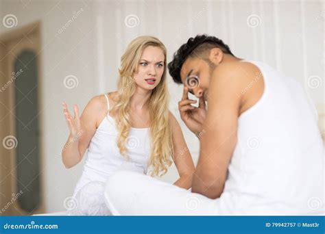 Young Couple Lying In Bed Having Conflict Relationships Problem Sad