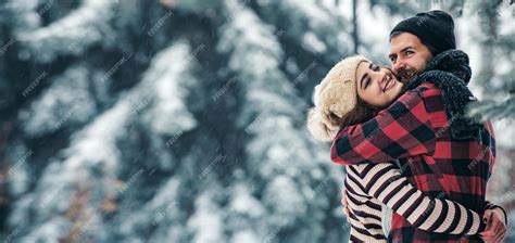 Premium Photo | Young couple hug in snow winter background couple in ...