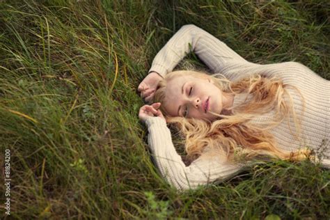 beautiful young girl lying on the grass dreaming Stock Photo | Adobe Stock