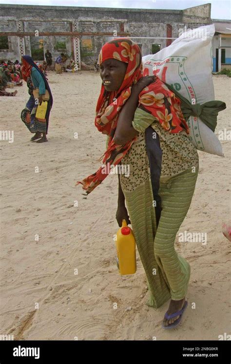 Somali Women From Southern Somalia Walk After Receiving Rations At A