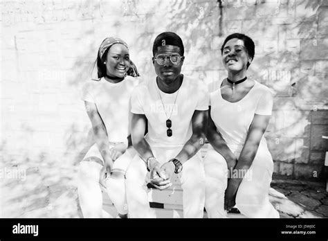 Three Stylish African American Friends Wear On White Clothes Sitting