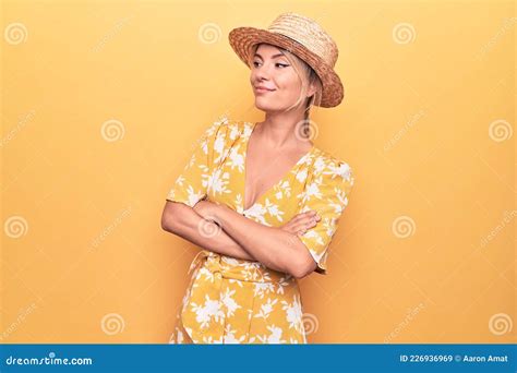 Beautiful Blonde Woman On Vacation Wearing Summer Hat And Dress Over