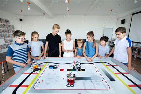 Robotics competitions. A group of children assembled robots from plastic parts in a robotics ...