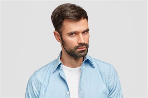 Free Photo Confident Unshaven Guy With Dark Bristle And Hair Listens Attentively Boss