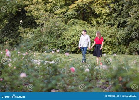 Young Couple In Love Walking In The Park Holding Hands Stock Image