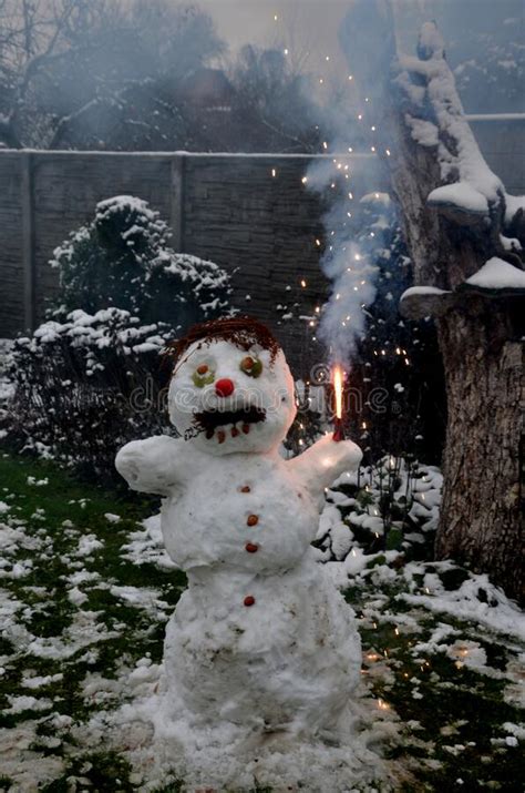 Snowman With The Grimace Of A Crazy Brawler Fan Lighted Stock Photo