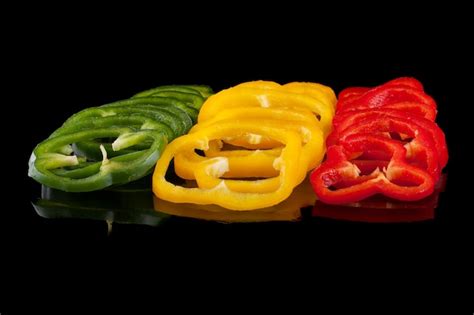 Premium Photo Red Green And Yellow Peppers Sliced Rings On A Black