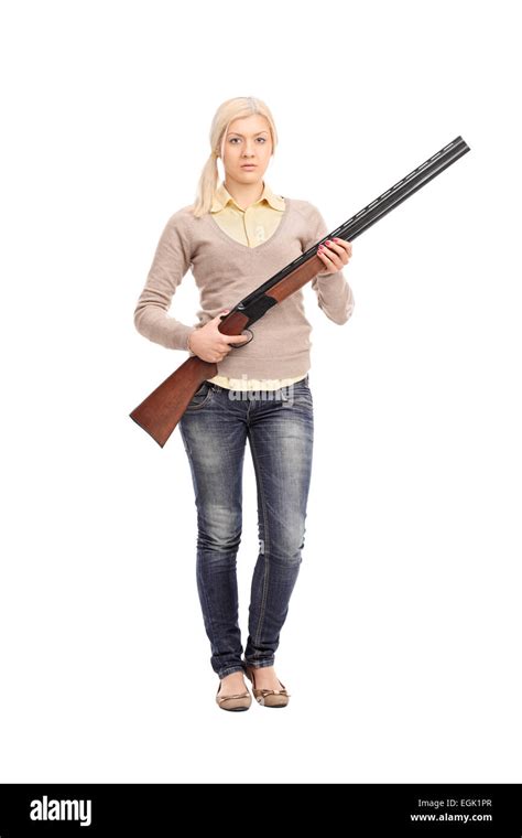 Full Length Portrait Of A Serious Girl Holding A Shotgun Isolated On