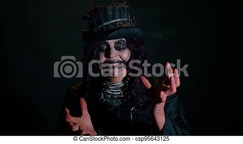 Sinister Senior Mature Woman In Carnival Costume Of Halloween Witch