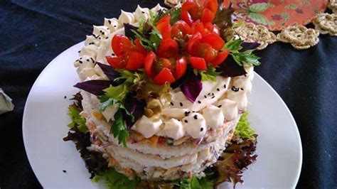 There Is A Very Large Layered Cake On The Plate With Red Flowers In The