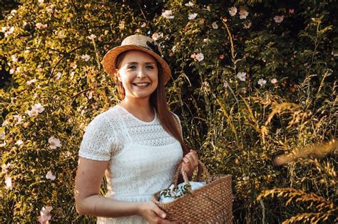 Premium Photo Pretty Woman In Hat Holding Basket With Flowers