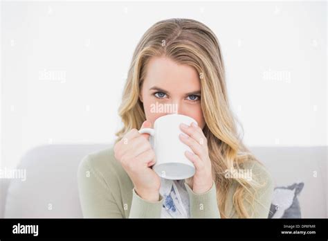 Cute Blonde Drinking Coffee Sitting On Cosy Sofa Stock Photo Alamy