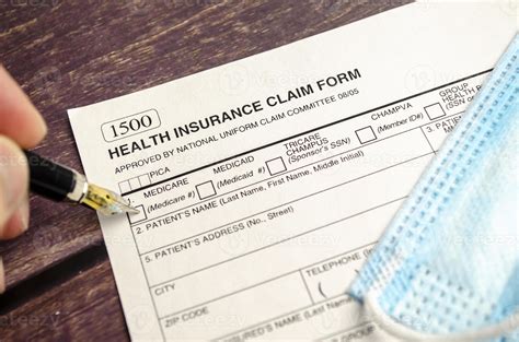 health insurance form with pen on wooden background 9691183 Stock Photo