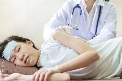 Sick Asian Child Girl Using Cold Gel Placed On Her Forehead To Relief