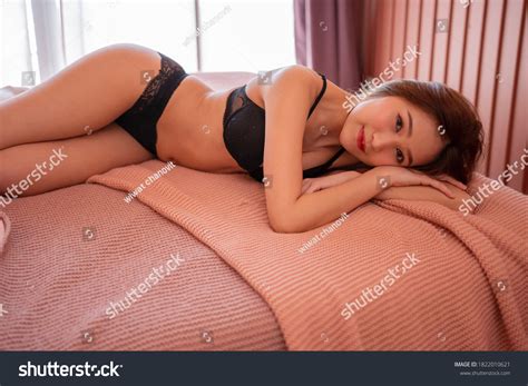 Sexy Asian Women Black Lingerie Laying Stock Photo