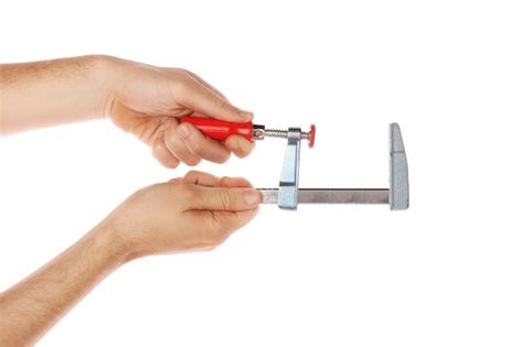 Premium Photo Cropped Hand Holding Work Tool Against White Background