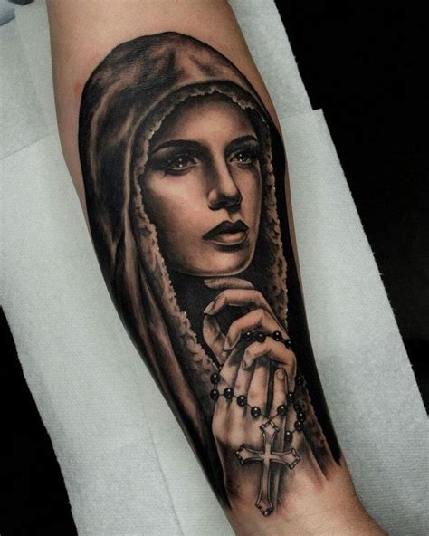 A Woman With A Rosary Tattoo On Her Arm