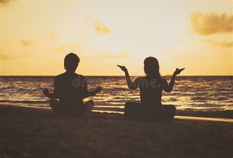 Silhouette of Couple Doing Yoga at Sunset Stock Photo - Image of beach ...