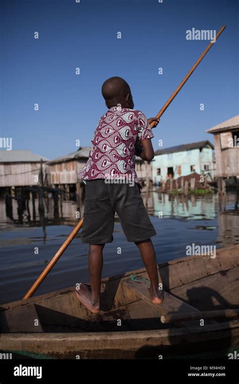 A young resident of Ganvie in lake Nokoué paddles his boat through