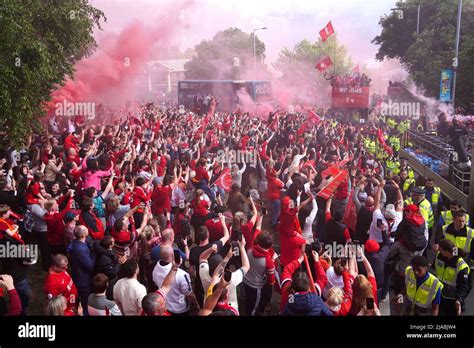 Liverpool Fans React As The Team Busses Pass By During The Trophy