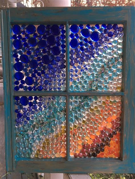 an old window is decorated with glass bottles