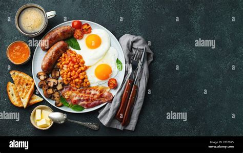 Full English Breakfast On A Plate With Fried Eggs Sausages Bacon