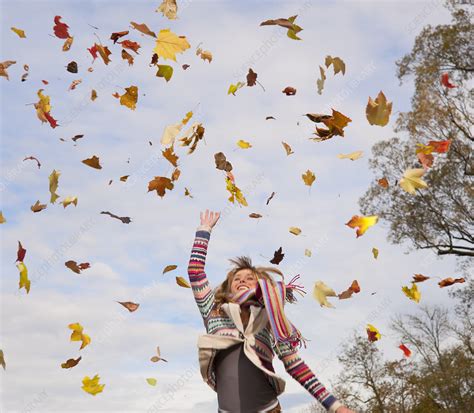 Woman Playing In Fall Leaves Stock Image F005 1415 Science Photo