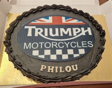 A Cake With The Words Triumph Motorcycles On It