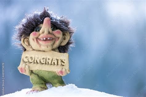 Cute happy troll holding sign with the word congrats chiseled out. Soft ...