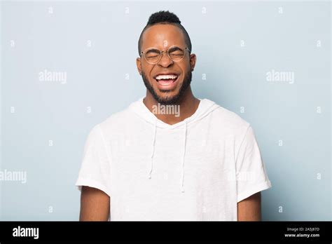 Portrait Of Overjoyed African American Man In Glasses Laughing Stock