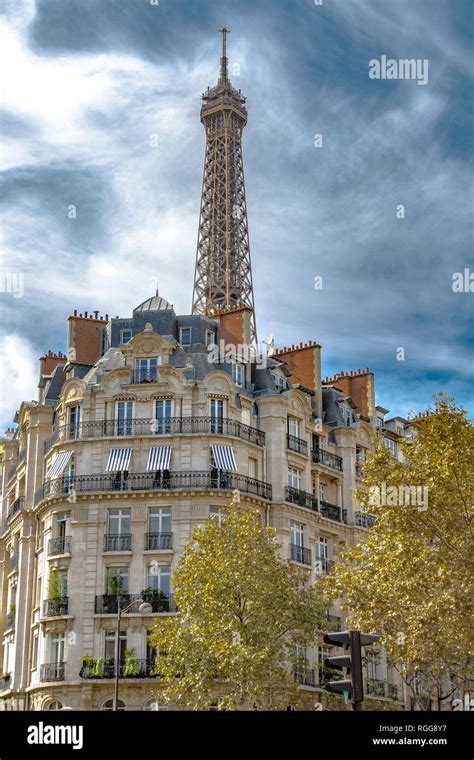 The Eiffel Tower rises above elegant Parisian apartment buildings with