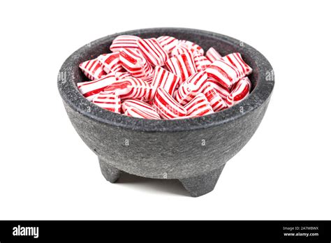 Red and white striped holiday candy isolated over white Stock Photo - Alamy