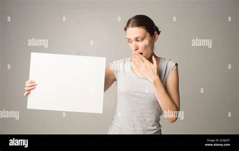 Woman Holding A Sheet Of Paper In Her Hand Stock Photo Alamy