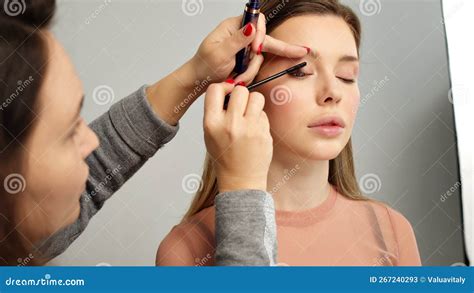 Make Up Artist In Photo Studio Doing Makeup For Beautiful Girl Woman