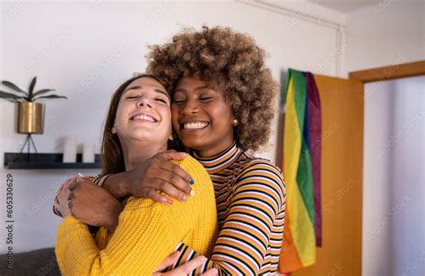 Beautiful And Cheerful Multiracial Lesbian Couple Hugging At Their