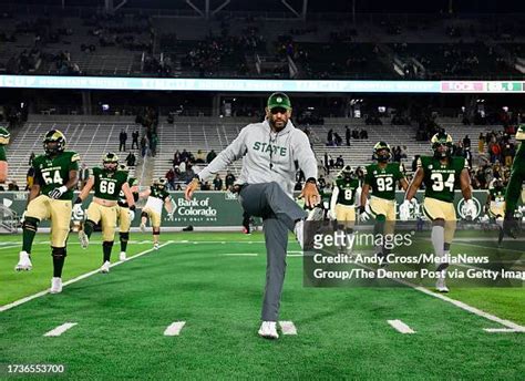 Colorado State Rams Head Coach Jay Norvell Stretches With His Team