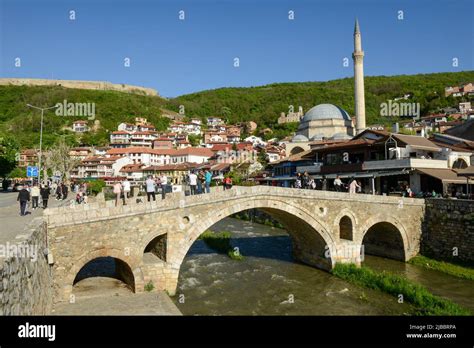 Prizren, Kosovo - 5 May 2022: people walking over the old bridge of ...