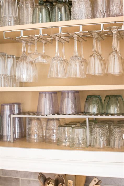 Shelves Filled With Glasses And Vases On Top Of Each Other