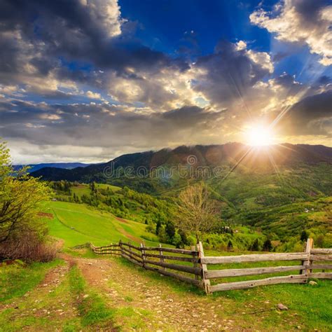 Fence On Hillside Meadow In Mountain At Sunset Stock Image Image Of