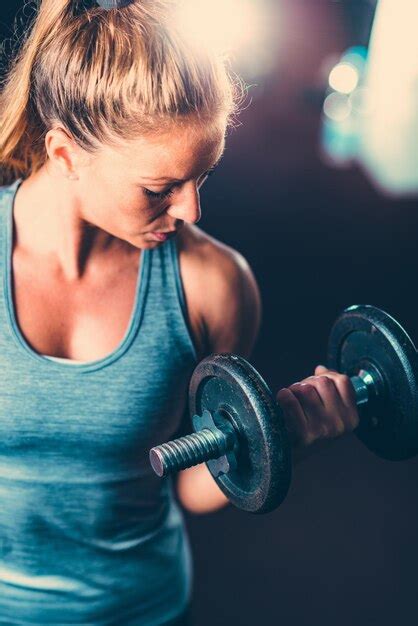 Premium Photo Close Up Of Mid Adult Woman Lifting Dumbbell