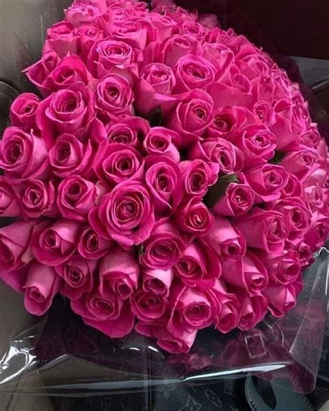 A Large Bouquet Of Pink Roses In A Car