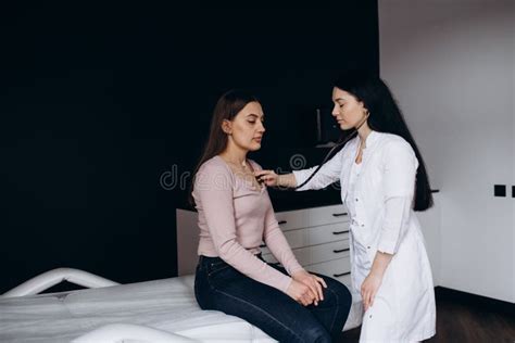 Doctor Listening Stethoscope With To Heart Of Young Female Patient