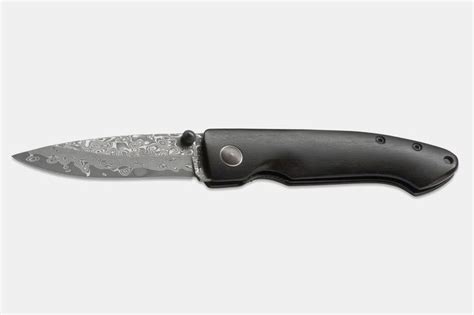 A Knife With A Black Handle On A White Background