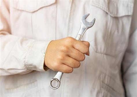 Cropped Shot Of Auto Mechanic With Wrench In Hands At Mechanic Shop