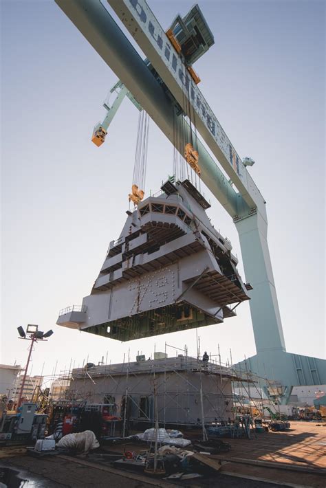 The island of the USS John F. Kennedy (CVN-79) is lifted out of the ...