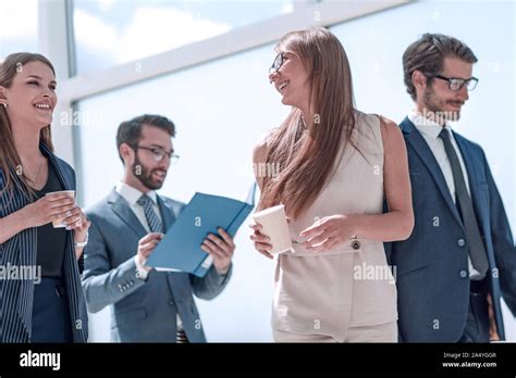 Group Of Business People Passing Through The Office Corridor Stock