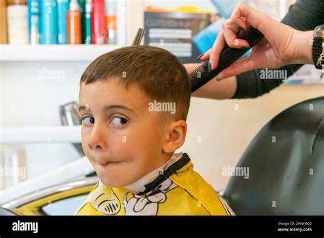 Little Boy Having A Haircut At Hair Salonchildren Hairdresser With