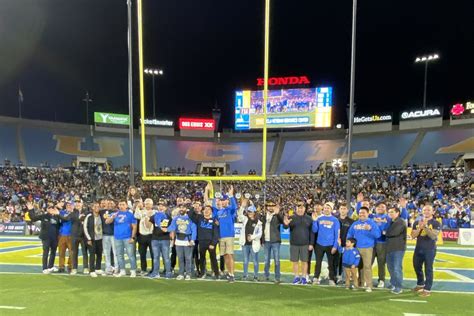 Photo | Group of about 20 UCLA veterans on the field at the Rose Bowl | UCLA